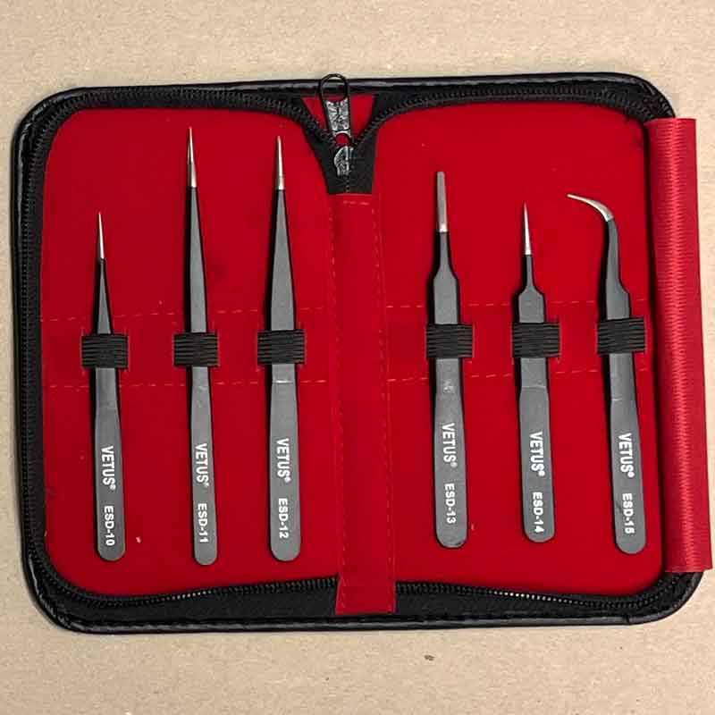 Set of 6 ESD-Safe Vetus tweezers in a red case on a beige background