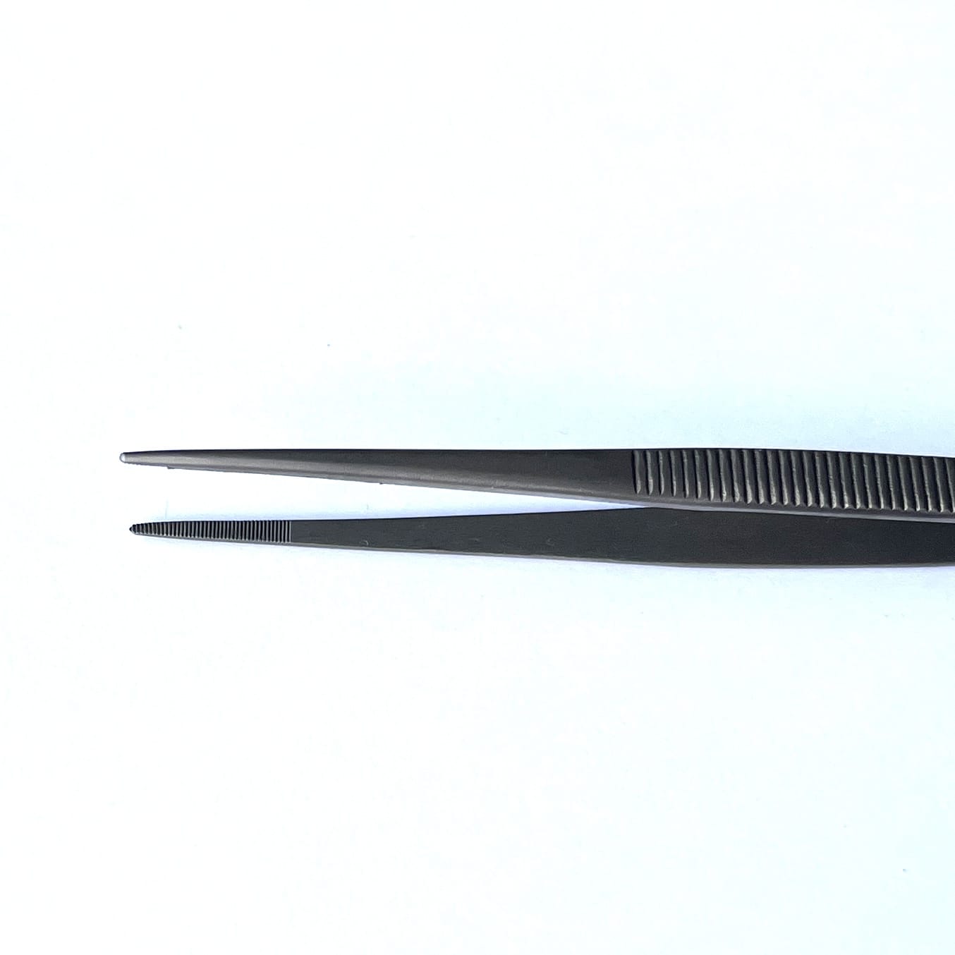 long-titanium-tweezers-with-medium-fine-serrated-tips- and serrated handle