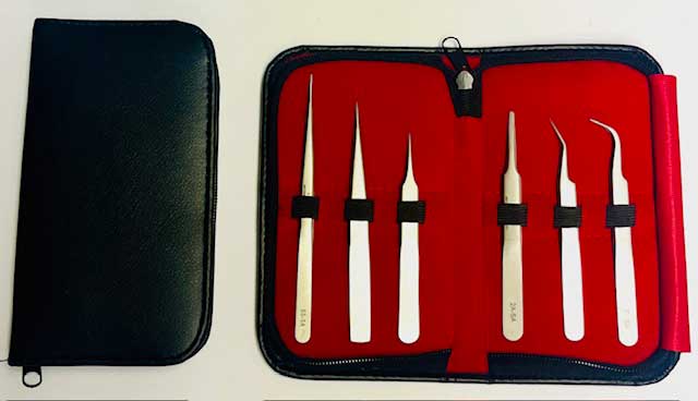 Set of six tweezers in a red inside case with a black cover on a white background